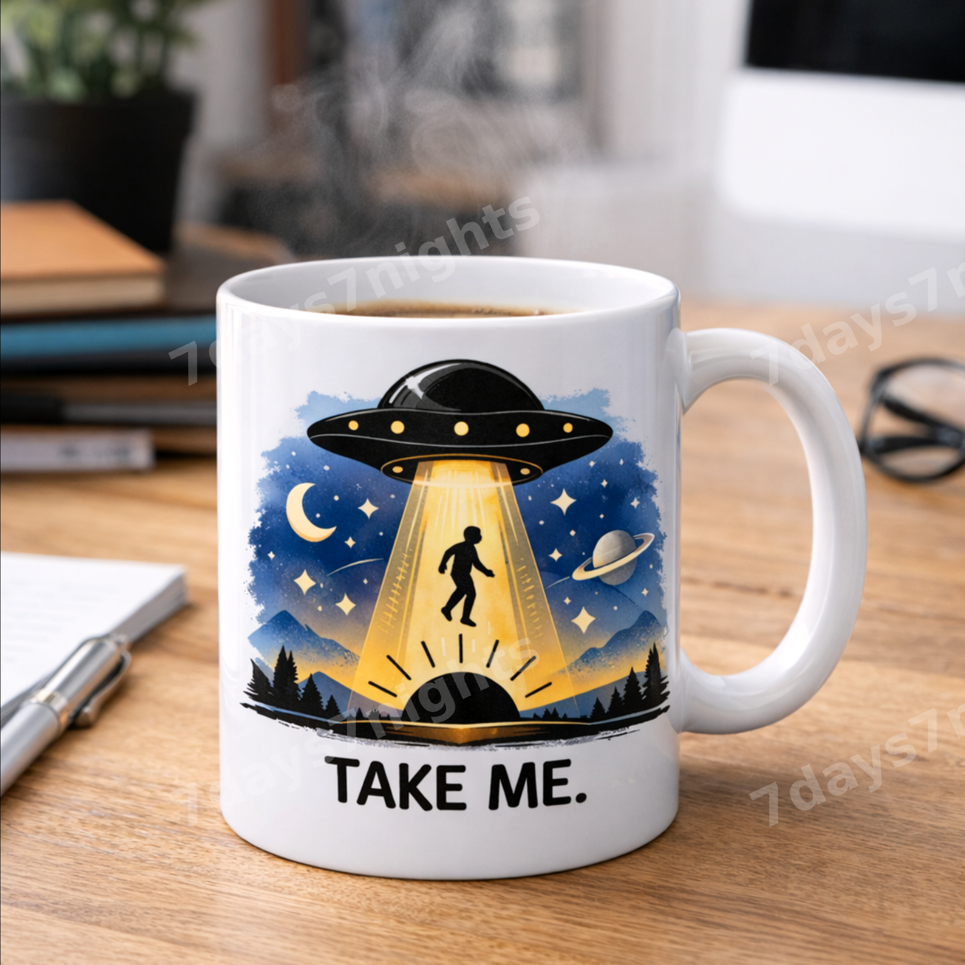 UFO mug on desk with notebook and pen.