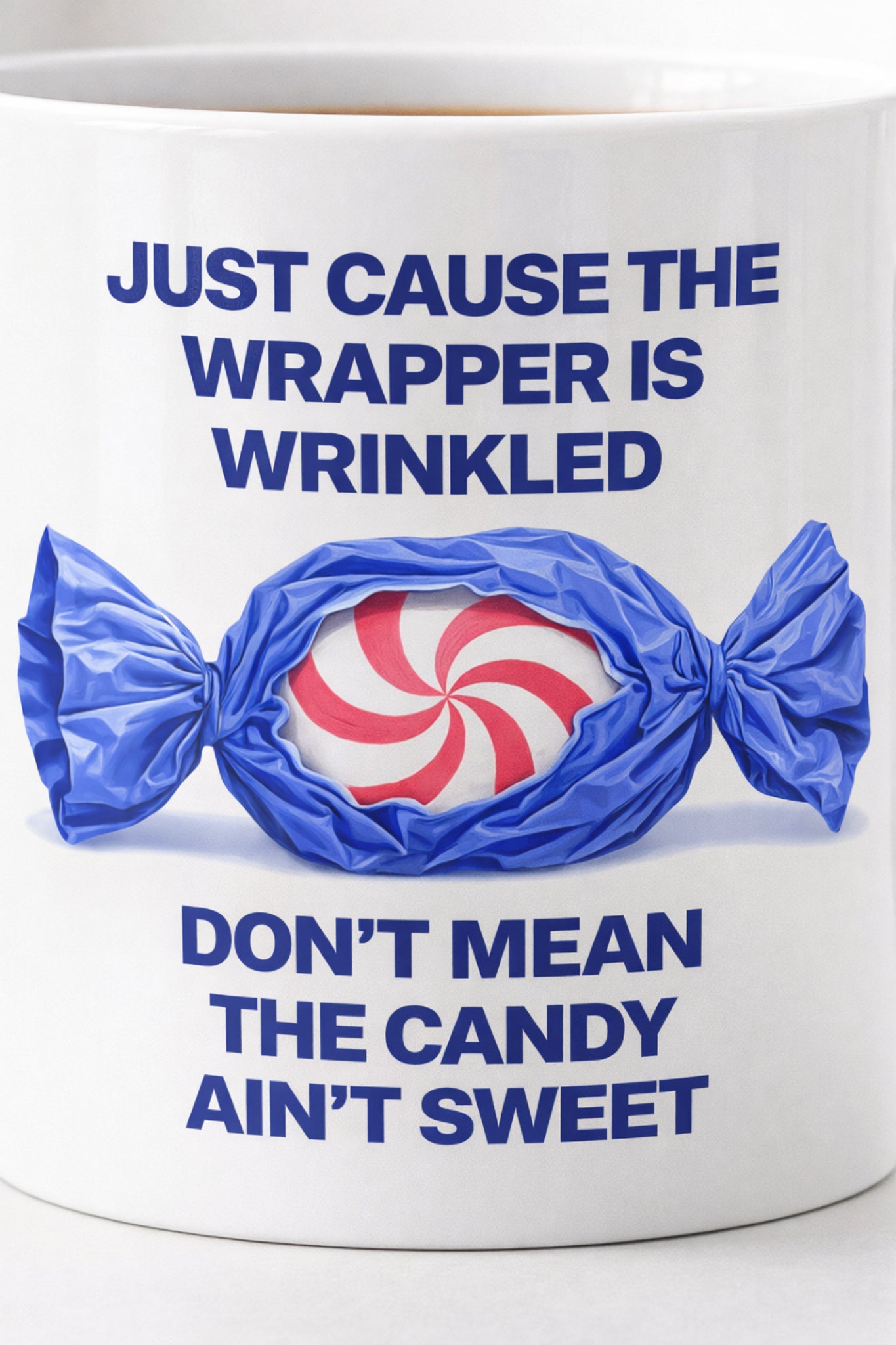 Close-up of quote typography and candy illustration on ceramic mug