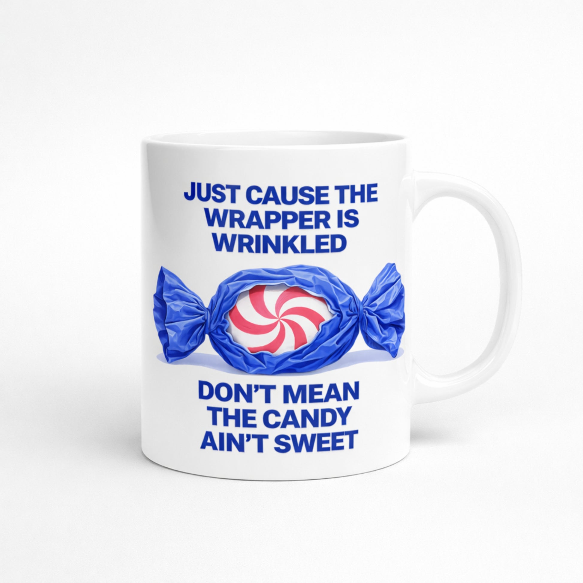 White ceramic mug with quote “Just Cause the Wrapper Is Wrinkled Don’t Mean the Candy Ain’t Sweet”