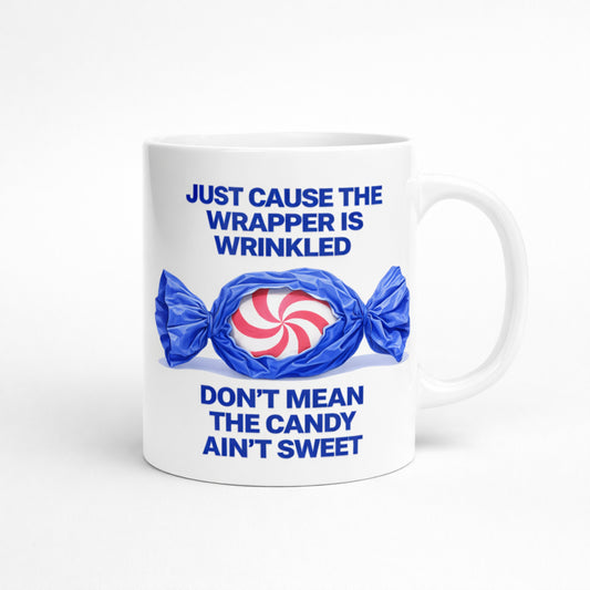 White ceramic mug with quote “Just Cause the Wrapper Is Wrinkled Don’t Mean the Candy Ain’t Sweet”
