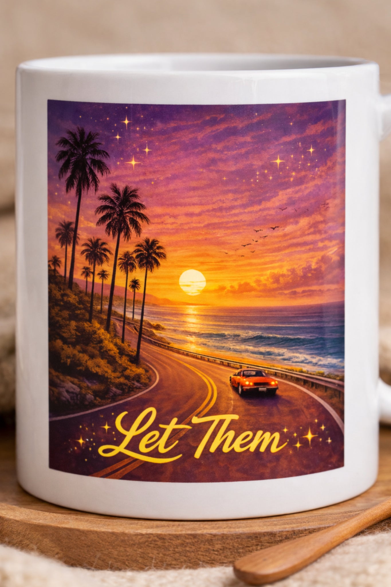 Close-up of sunset road artwork and Let Them text on ceramic mug
